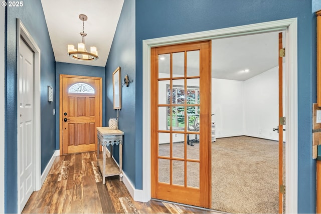 39225 SW Oak Ln, Willamina, OR 97396 - doorway to outside featuring baseboards, dark wood-style flooring, a chandelier, and a textured wall