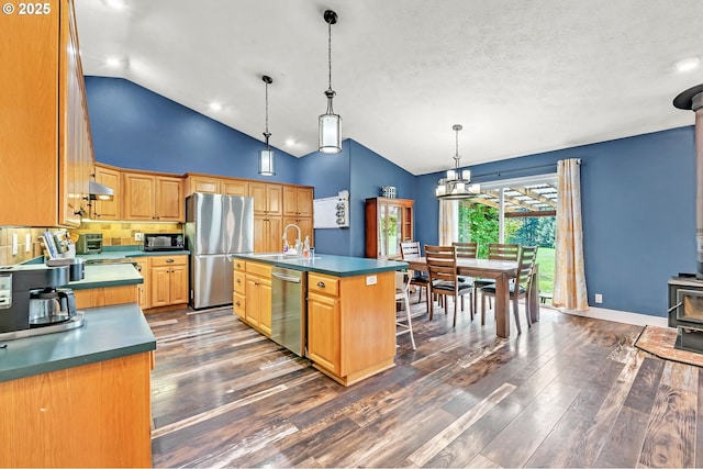 39225 SW Oak Ln, Willamina, OR 97396 - kitchen featuring stainless steel appliances, a sink, high vaulted ceiling, dark wood-style flooring, and under cabinet range hood