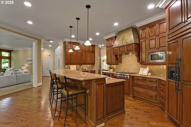 kitchen with appliances with stainless steel finishes, ornamental molding, custom range hood, and dark wood finished floors