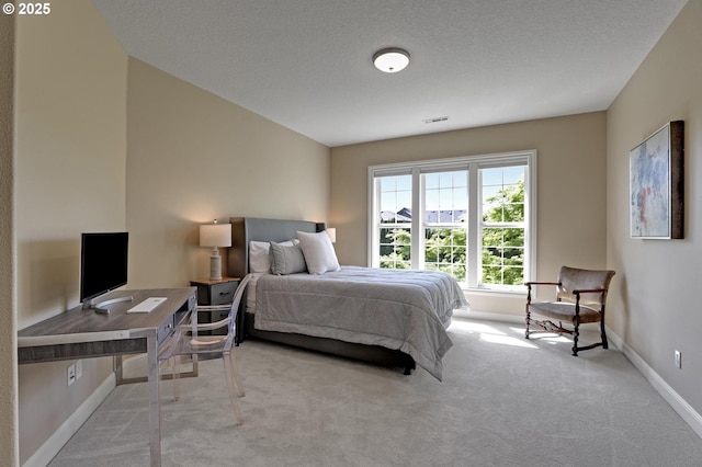 carpeted bedroom with baseboards and visible vents