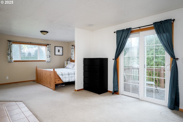 unfurnished bedroom featuring carpet, a textured ceiling, and access to exterior