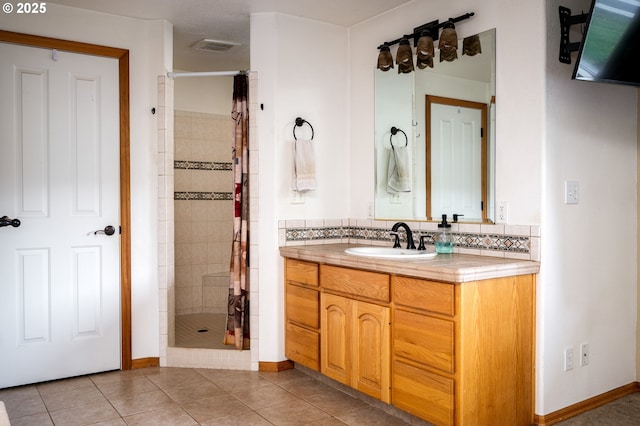 bathroom with tile patterned flooring, vanity, backsplash, and a shower with shower curtain