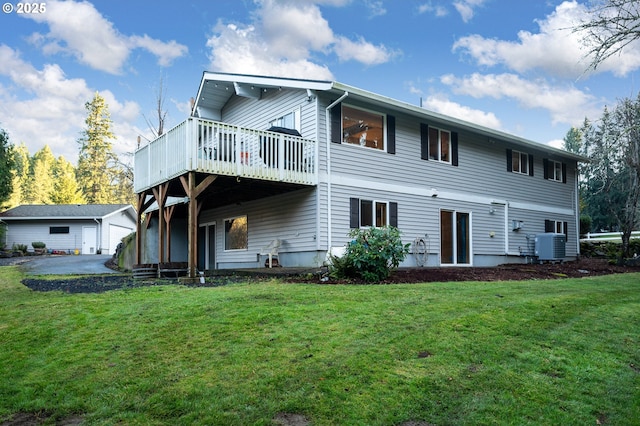 rear view of property featuring a lawn, an outbuilding, and a garage