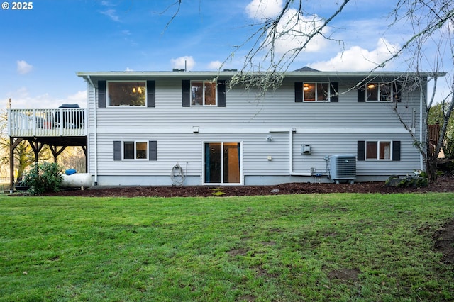 rear view of property featuring central AC, a yard, and a deck