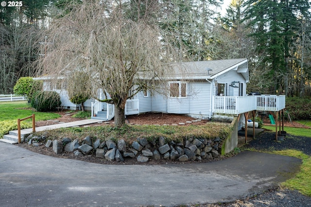 view of front facade with a wooden deck