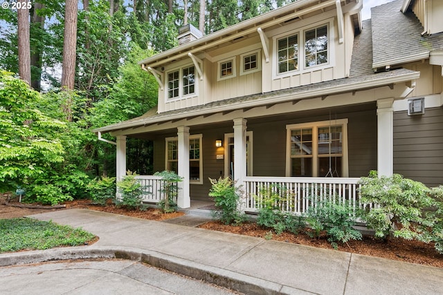 4520 Trillium, Woods, Lake Oswego, OR 97035 - view of front of home featuring covered porch, board and batten siding, a chimney, and roof with shingles