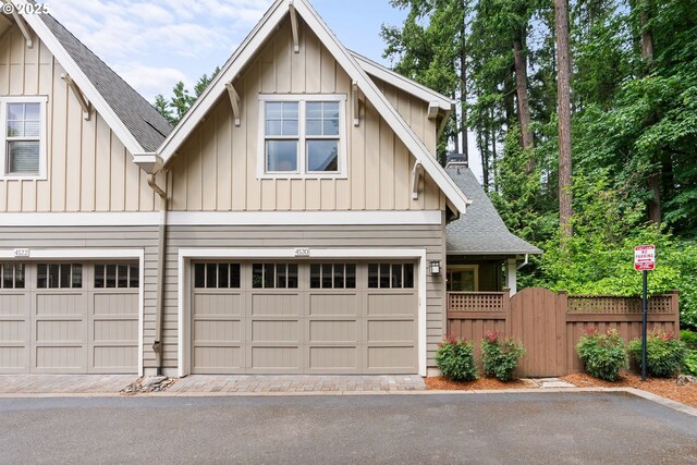 4520 Trillium, Woods, Lake Oswego, OR 97035 - view of front of home featuring board and batten siding, roof with shingles, a gate, driveway, and an attached garage