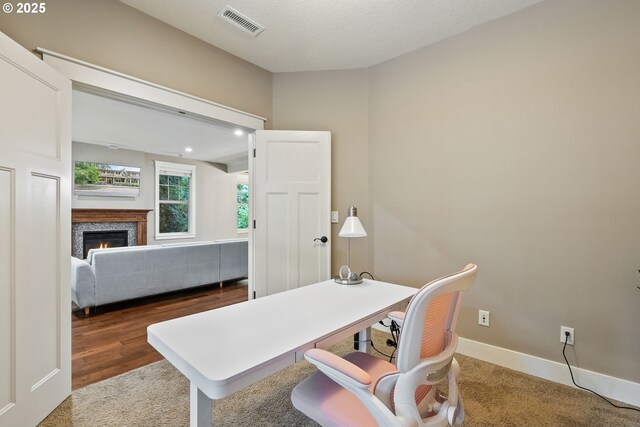 4520 Trillium, Woods, Lake Oswego, OR 97035 - carpeted home office featuring a warm lit fireplace and baseboards