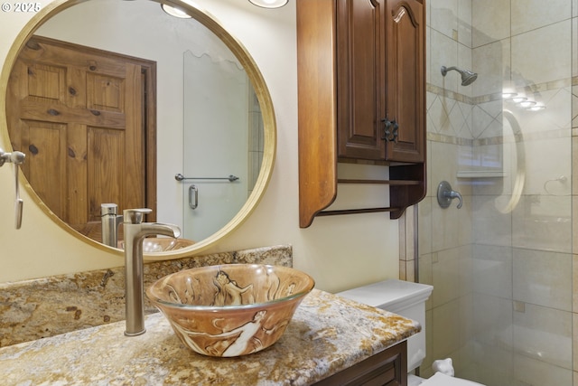 bathroom with vanity, walk in shower, and toilet