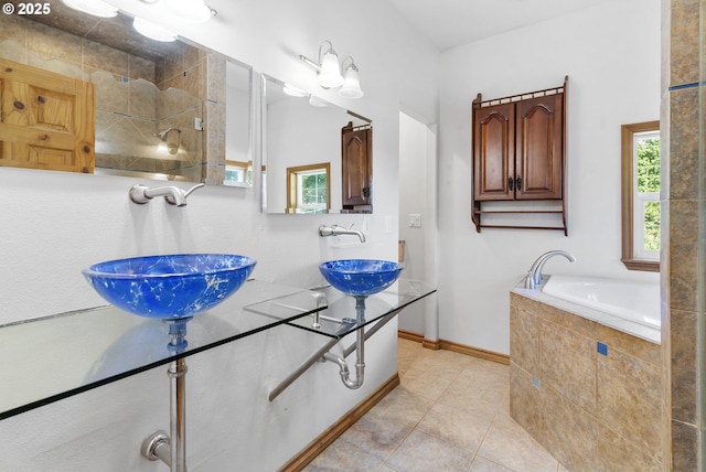 bathroom featuring tile patterned flooring and tiled bath