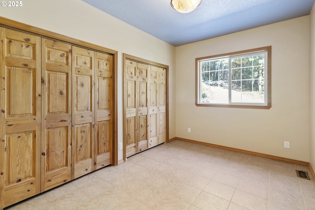 unfurnished bedroom with a textured ceiling