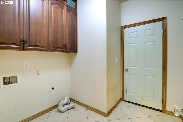 washroom with hookup for a washing machine, cabinets, hookup for an electric dryer, and light tile patterned floors