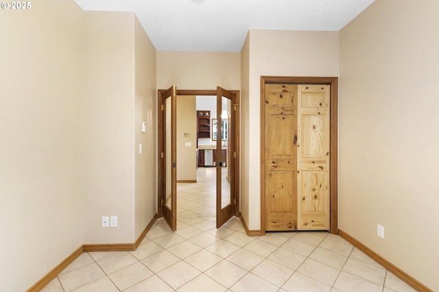 hall with light tile patterned floors