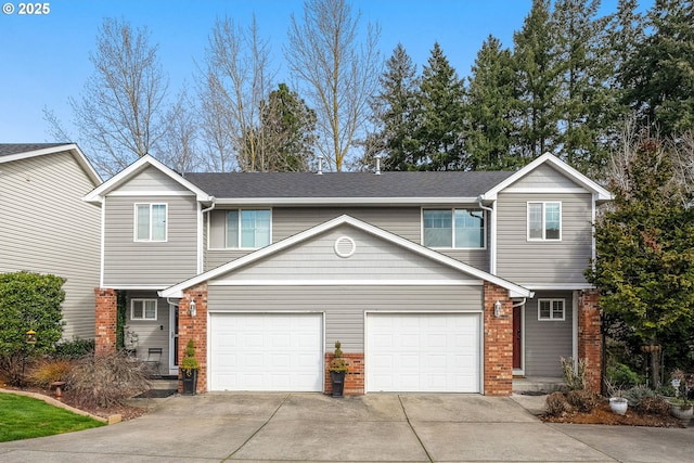 view of property with brick siding and concrete driveway