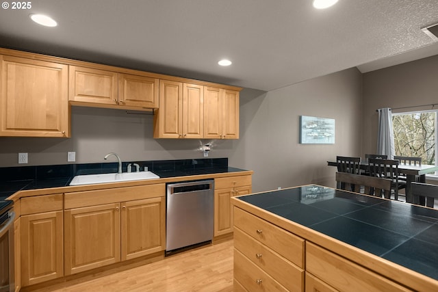 kitchen featuring stainless steel dishwasher, tile countertops, light brown cabinets, and a sink