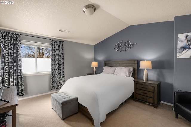 carpeted bedroom with visible vents, lofted ceiling, a textured ceiling, and baseboards