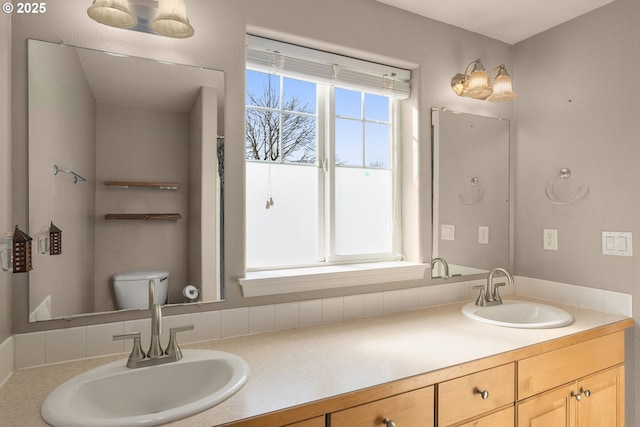 bathroom featuring a sink and double vanity