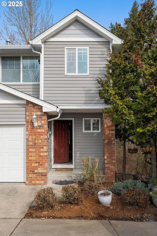 traditional-style house featuring brick siding and a garage