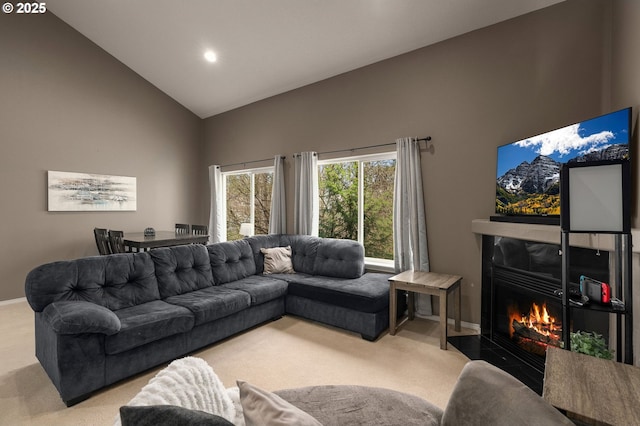 carpeted living area with recessed lighting, baseboards, high vaulted ceiling, and a high end fireplace