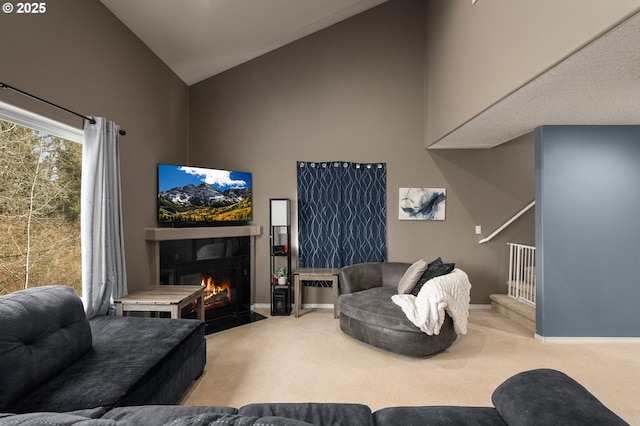 living room with baseboards, a fireplace with flush hearth, high vaulted ceiling, and carpet