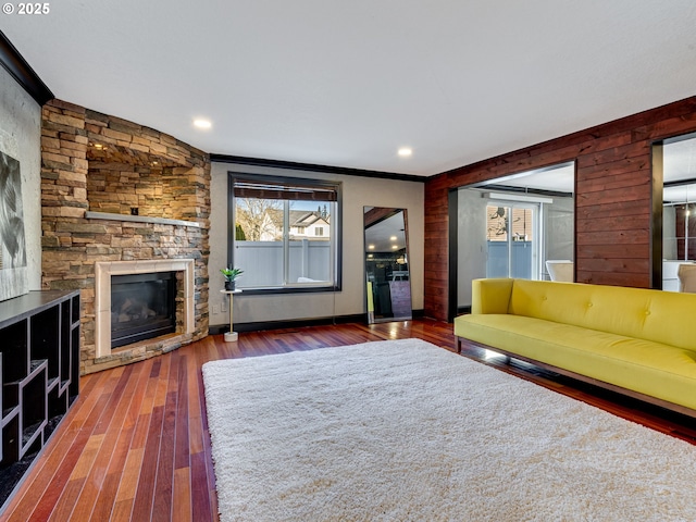 unfurnished living room featuring recessed lighting, a fireplace, and wood finished floors