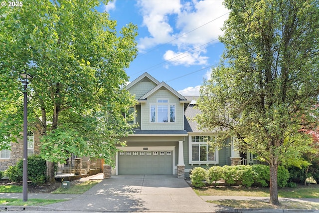 11168 SW Brown St, Tualatin, OR 97062 - craftsman house with concrete driveway, an attached garage, stone siding, and roof with shingles