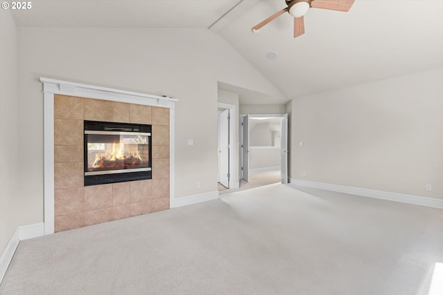 11168 SW Brown St, Tualatin, OR 97062 - unfurnished living room with light colored carpet, ceiling fan, vaulted ceiling, a tile fireplace, and baseboards