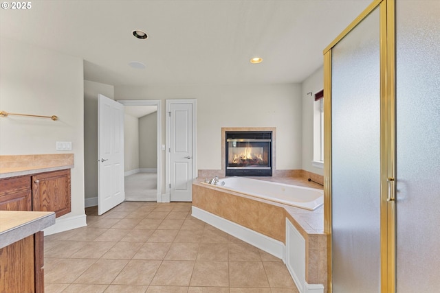 11168 SW Brown St, Tualatin, OR 97062 - bathroom featuring vanity, a garden tub, a multi sided fireplace, a stall shower, and tile patterned floors
