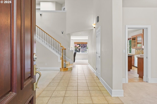 11168 SW Brown St, Tualatin, OR 97062 - entrance foyer featuring light tile patterned flooring, stairs, a high ceiling, and baseboards