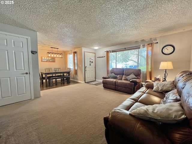 160 Heather Dr, Stanfield, OR 97875 - living area with carpet flooring, a chandelier, and a textured ceiling