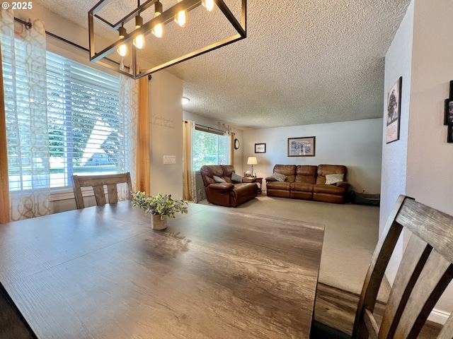 160 Heather Dr, Stanfield, OR 97875 - carpeted dining area with a textured ceiling and a chandelier