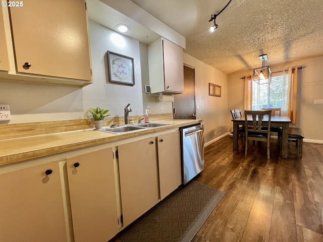 160 Heather Dr, Stanfield, OR 97875 - kitchen with stainless steel dishwasher, a sink, light countertops, dark wood-style flooring, and a textured ceiling