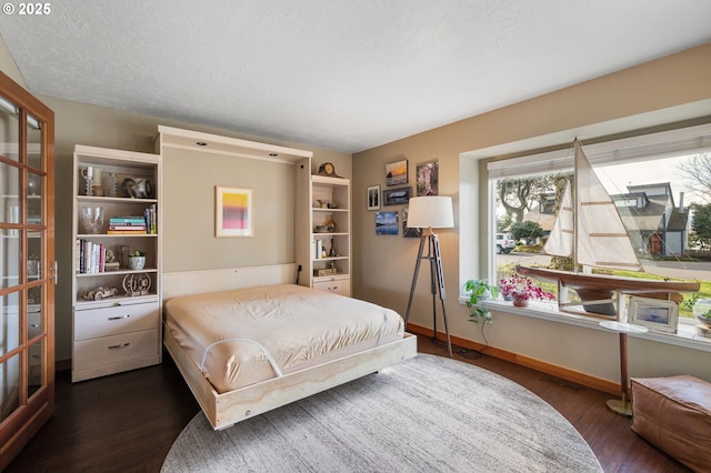 bedroom with dark hardwood / wood-style flooring and a textured ceiling