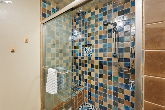 bathroom featuring a shower with door