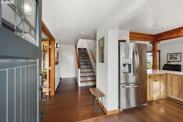 kitchen with stainless steel refrigerator with ice dispenser, dark wood-type flooring, and light brown cabinetry