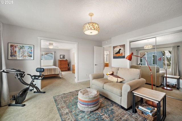 living room with a healthy amount of sunlight, carpet flooring, and a textured ceiling