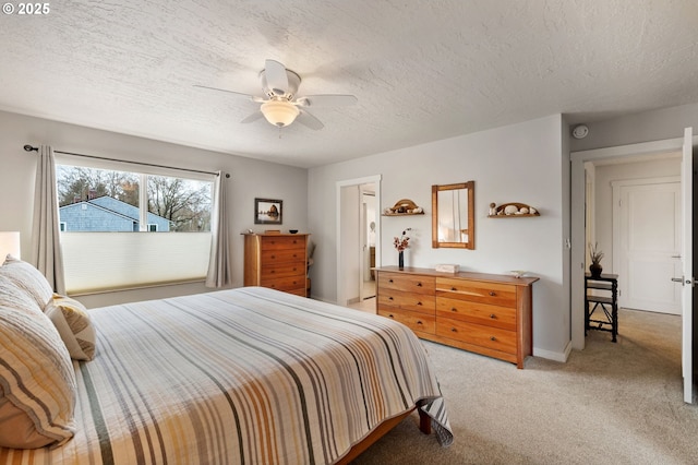 bedroom with light carpet, a textured ceiling, and ceiling fan