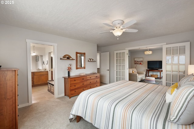 bedroom featuring light carpet, ceiling fan, and a textured ceiling