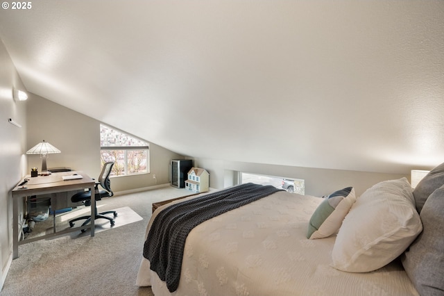 carpeted bedroom with lofted ceiling