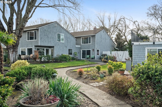 rear view of house with a yard