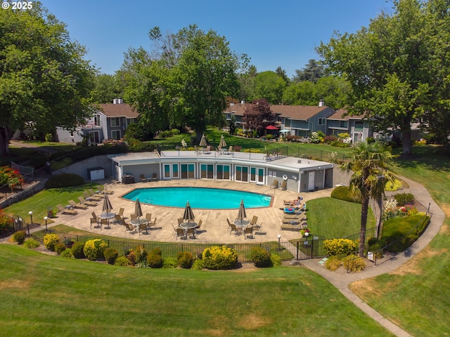 view of pool featuring a yard and a patio