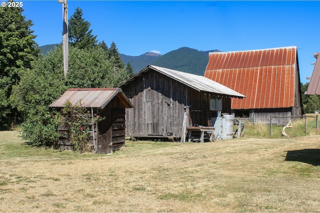 view of outbuilding with a mountain view and a yard