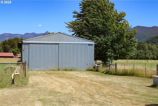 view of outdoor structure featuring a mountain view and a yard