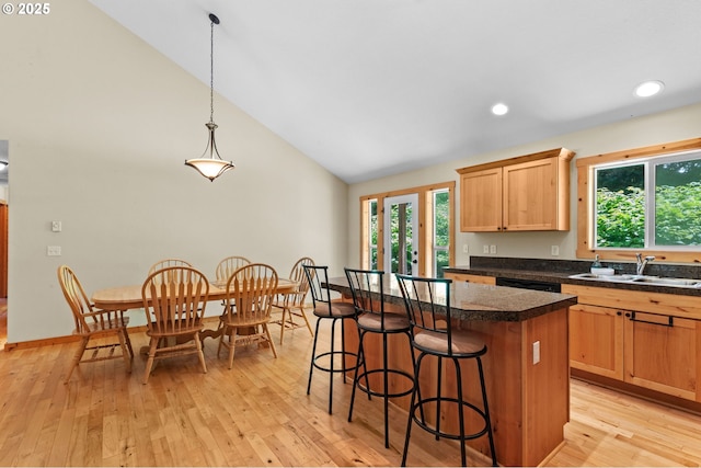 1430 N Cedar Creek Cir, Rockaway Beach, OR 97136 - kitchen with light wood-type flooring, plenty of natural light, a breakfast bar, a center island, and recessed lighting