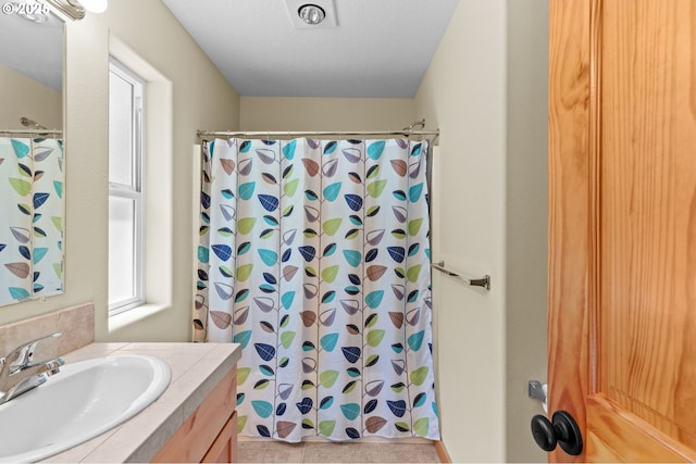 1430 N Cedar Creek Cir, Rockaway Beach, OR 97136 - bathroom featuring vanity, a shower with shower curtain, and tile patterned flooring