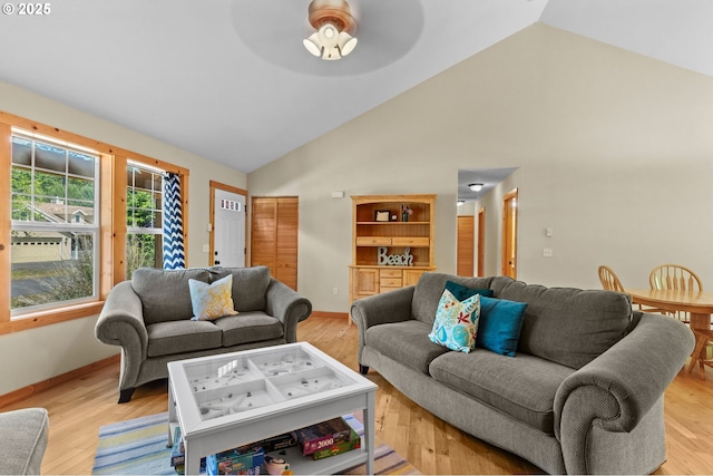 1430 N Cedar Creek Cir, Rockaway Beach, OR 97136 - living room featuring a ceiling fan, high vaulted ceiling, and light wood-style flooring