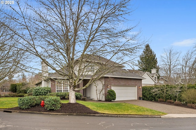 view of front of property with a garage and a front yard