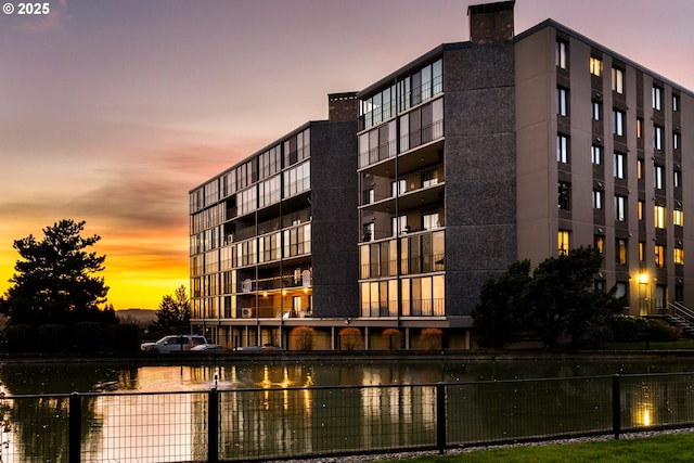 outdoor building at dusk featuring a water view