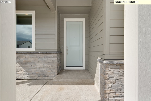 doorway to property with stone siding