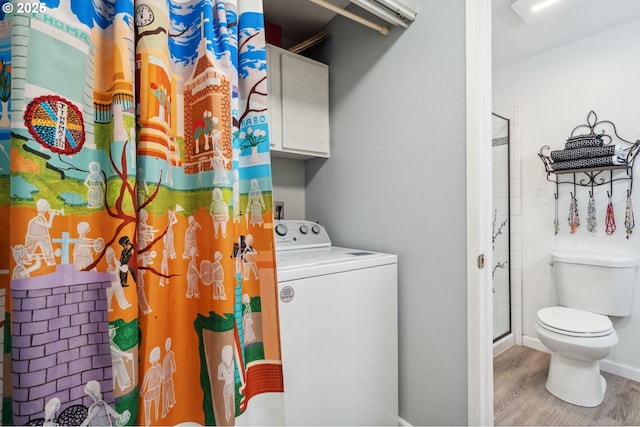 washroom featuring laundry area, washer / dryer, and wood finished floors